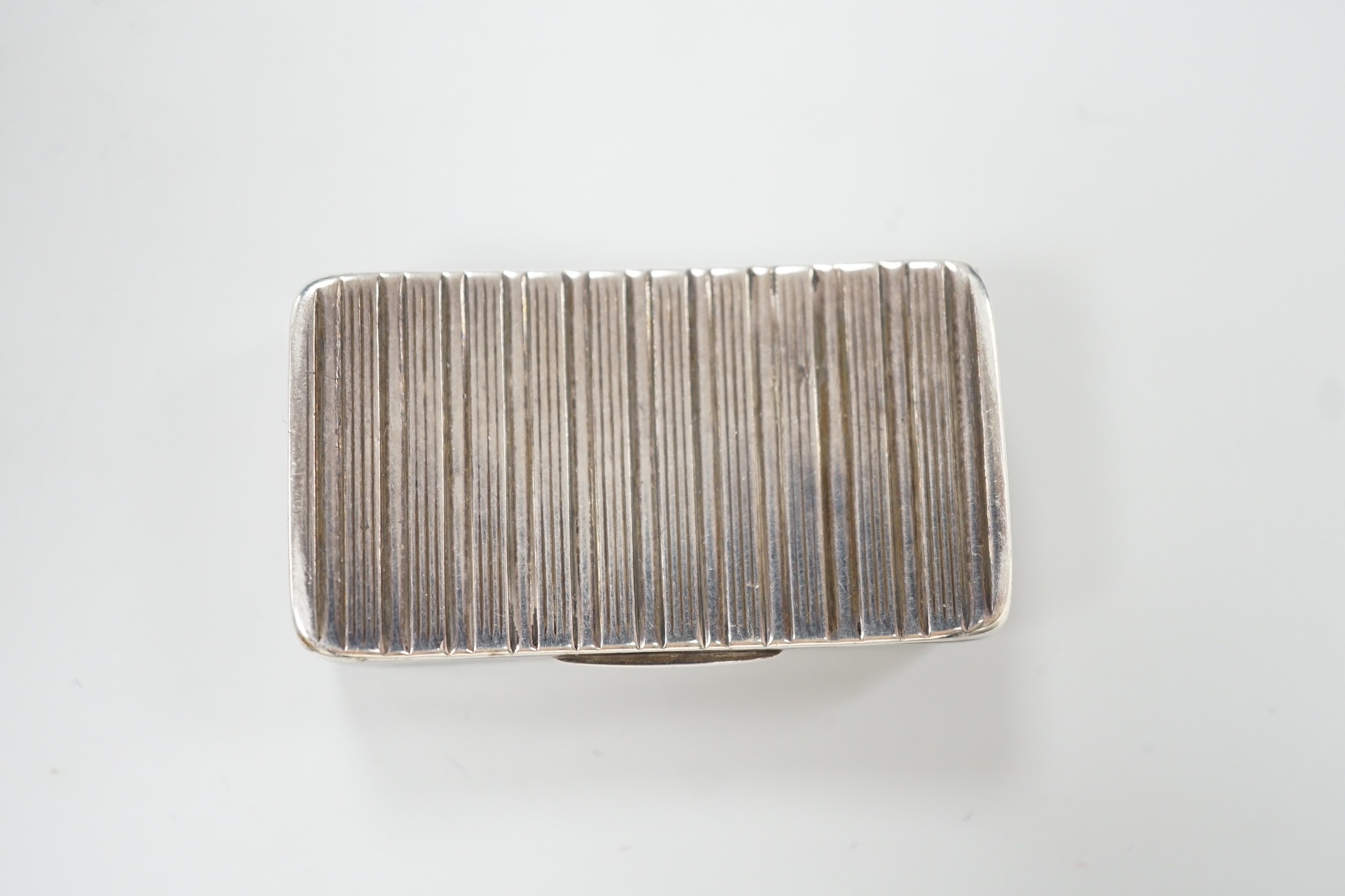 A George III ribbed silver snuff box, maker ?S, Birmingham, 1810, 58mm.